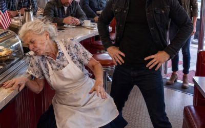 When a bu:lly sh0ved my 75-year-old mother during a confrontation in her North Carolina diner and warned he could do whatever he wanted, the regulars lowered their eyes and the sheriff called it a fall. I came home quietly, preserved the video he thought was incomplete, and waited beside the counter—until two black SUVs stopped outside and an officer entered using a rank no one knew I held. The video lasted twelve seconds. I was standing inside a briefing room at Fort Bragg, North Carolina, when my phone vibrated against the conference table. Twelve officers were reviewing logistics around me, and I still had a laser pointer in my hand when I saw my neighbor Carol’s name on the screen. “Nicole,” she said, her voice shaking. “You need to see what happened to your mother.” The video arrived before she finished. I stepped into the hallway and pressed play. Turner’s Family Diner appeared on my screen—the same red vinyl booths, chrome-edged tables, and brass bell over the door that had been there since childhood. My mother, Evelyn Turner, stood behind the counter in her faded apron. At seventy-five, she still opened before sunrise, knew every regular’s coffee order, and refused to replace an apron stained in the shape of Ohio because she claimed it had “another ten good years left.” A man leaned across the counter with one finger near her face. I recognized him from photographs almost immediately. Travis Cain. His father, Wade Cain, owned half the commercial property in the county and had spent months pressuring my mother to sell the diner’s lease and the narrow parcel behind it. My mother shook her head. Then she made the gesture I had known all my life—both hands raised slightly, palms outward. No. She would not sign. She would not sell. Travis raised his hand. My mother lost her balance and fell beside the counter. Her glasses slid beneath a booth while the customers stared into their plates. Nobody moved. These were people she had fed on credit. People whose children she had watched grow up. Men who had spent twenty years discussing football, crops, and local politics over her coffee. Not one of them stood. Travis adjusted his jacket and looked around the diner as if he wanted everyone to remember who controlled the room. “Around here,” he said, “I do whatever I want.” The video ended. I requested emergency leave before returning to the briefing room. I had served in the U.S. Army for more than twenty years. I commanded a Ranger battalion and had spent most of my adult life learning to make decisions under pressure. But on the flight home, rank meant nothing. I was simply a daughter replaying twelve seconds she could not change. My mother was in a hospital outside town with a injuries to her shoulder and a bru:ising on her face. When I entered her room, she did not look relieved. She looked frightened. “You should not have come,” she said. “Someone put you on the floor of your own restaurant.” “I’m fine.” Her good hand closed around mine. The grip was still strong, but her eyes moved toward the door before she continued. “Please don’t make this bigger.” “What does Wade Cain want?” She pulled the blanket higher over her waist. “The diner. The land behind it. Your father refused him years ago, and now I have refused him too.” My father had died six years earlier in a single-vehicle accident on Route 9. The road had been dry. He had driven it thousands of times. Until that moment, I had never connected his death to the Cain family. “Don’t gather a storm,” my mother whispered. It was an old expression she used whenever she wanted me to leave trouble alone. But the trouble had already entered her diner. The following morning, I spoke to the waitress, the cook, and two regulars who had been present. Each gave me a version of the same answer. “I didn’t see anything.” Their hands told a different story. The waitress, Kayla, wiped the same clean section of counter until her knuckles turned pale. One of the regulars held his coffee cup with both hands to stop it from trembling. The building owner claimed the security system had malfunctioned. Sheriff Don Harper called my mother’s injuries the result of “an unfortunate fall.” He never asked to see my phone. He never asked why Travis Cain appeared in the video. He folded his hands on his desk and said, “Without a cooperating witness, there is nothing meaningful to investigate.” That evening, someone knocked softly on my mother’s front door. Kayla stood on the porch wearing a gray hoodie. She kept looking toward the road. “I recorded more,” she said. Her phone contained forty-seven seconds, not twelve. The longer video showed Travis demanding my mother’s signature. It also showed a second man standing near the pie display in an expensive gray suit. Wade Cain watched everything. He never tried to stop his son. He did not even look surprised. I saved three copies of the video and sent one to a secure account before Kayla left. Then I began checking county property records. Thirty families had sold land to Cain Realty Group during the previous six years. Most had refused the first offer. Soon afterward, each experienced a sudden problem—a disputed lien, a failed inspection, missing permits, or unexplained damage. Every complaint had passed through Sheriff Harper’s office. Every zoning request connected to Cain Realty had been approved by Mayor Linda Brooks. Then I found my father’s name. An assessor’s file described him as “uncooperative” after he rejected Wade Cain’s third offer. The note recommending “e$c@lation” had been dated three weeks before my father’s acc:ident. I did not accuse anyone. I copied the page, photographed the original, and placed everything in a folder. The next morning, I returned to the diner in jeans and an old university sweatshirt. My hair was tied back, and nothing about me revealed my command or rank. My mother was already behind the counter with her arm in a sling. The bell rang. Travis Cain walked in smiling. “I hear your daughter has been digging through records,” he told my mother. “She is worried about me.” “She should worry about herself.” I rose from the corner booth. “You must be Travis.” He turned. “I’m Nicole. Evelyn’s daughter.” His smile widened. “So you’re the soldier girl.” He leaned against the counter and lowered his voice. “Let me explain something. Around here, my family decides what becomes a problem and what disappears.” “My father’s accident disappeared quickly.” For half a second, his expression changed. Then he smiled again. “Accidents happen to people who don’t know when to leave things alone.” My mother’s coffee pot stopped inches above a cup. I kept my voice level. “The law is coming, Travis. It is simply late.” He stood and pressed his shoulder into mine, testing whether I would react. I did not move. Sheriff Harper entered almost immediately. He looked at me instead of Travis. “Ms. Turner, you need to leave. We will not tolerate disturbances here.” Then two black SUVs stopped outside the diner. The engines remained running. A man in a U.S. Army service uniform stepped from the first vehicle, removed his cap, and walked through the door. He looked past the sheriff, past Travis Cain, and directly at me. “Good afternoon, Colonel Turner.” A coffee cup slipped from someone’s hand and struck the counter. The story is too long to post in the caption, so just say you “Yes”. The full story will be in the comments below.