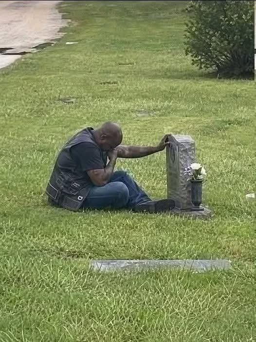 A BIKER CAME TO MY WIFE’S GRAVE EVERY SINGLE WEEK, AND FOR MONTHS, I HAD NO IDEA WHO HE WAS. _____ For six months, I watched him from inside my car. Same day. Same time. Every Saturday at exactly 2 PM, he would ride into the cemetery on his Harley, park near the old oak tree, and walk straight to Emily’s headstone. Then he would sit beside her grave for one full hour. He never brought flowers. Never left a note. Never spoke loud enough for me to hear. He just sat cross-legged in the grass, head lowered, like he was carrying a pain too heavy to stand with. The first time I saw him, I thought he had made a mistake. It was a large cemetery. Graves could be easy to confuse. But then he came back the next Saturday. And the Saturday after that. And again after that. Week after week, this stranger mourned my wife like she had belonged to him too. At first, I was confused. Then I became angry. Who was he? How did he know Emily? Why was this man showing up for her every week when some people in her own family barely came at all? Emily had died fourteen months earlier from breast cancer. She was only forty-three. We had been married for twenty years. Two children. A quiet home. A normal life. At least, that was what I thought. Nothing about my wife’s life made sense with this man. Emily had been a pediatric nurse. She volunteered at church. She drove a silver minivan and packed snacks for every school event. Her idea of breaking the rules was ordering dessert before dinner. But this biker grieved her like he had lost someone irreplaceable. Sometimes, from my car, I saw his shoulders shake. Sometimes, before he left, he placed one rough hand against her headstone and kept it there for several seconds. Like he was saying goodbye all over again. By the third month, I could not take it anymore. That Saturday, I stepped out of my car and walked toward him. He heard my footsteps but did not turn around. His hand stayed pressed against Emily’s name. “Excuse me,” I said, my voice sharper than I intended. “I’m Emily’s husband. I think it’s time you told me who you are.” For a long moment, he said nothing. Then he slowly stood, turned toward me, and looked like a man who had been waiting six months for this question. Finally, he said: “Your wife was my…” Type “0503” and hit “Like” to see the full story.